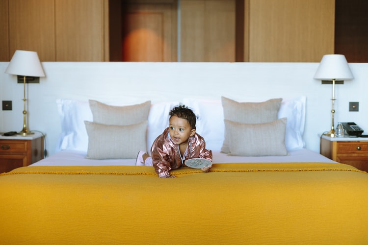 Baby laying on a bed