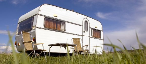 a caravan in a field of grass